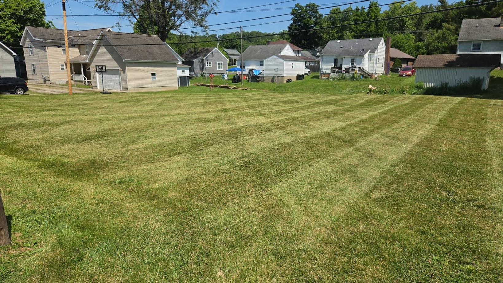 Landscaping crew installing fresh mulch and plants along a home